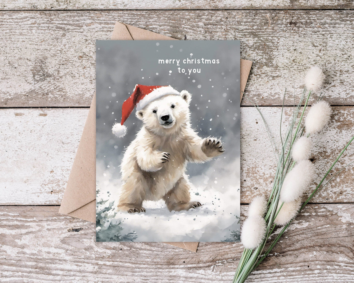 Cute Polar Bear on a Christmas card with Santa hat wishing you a Merry Christmas