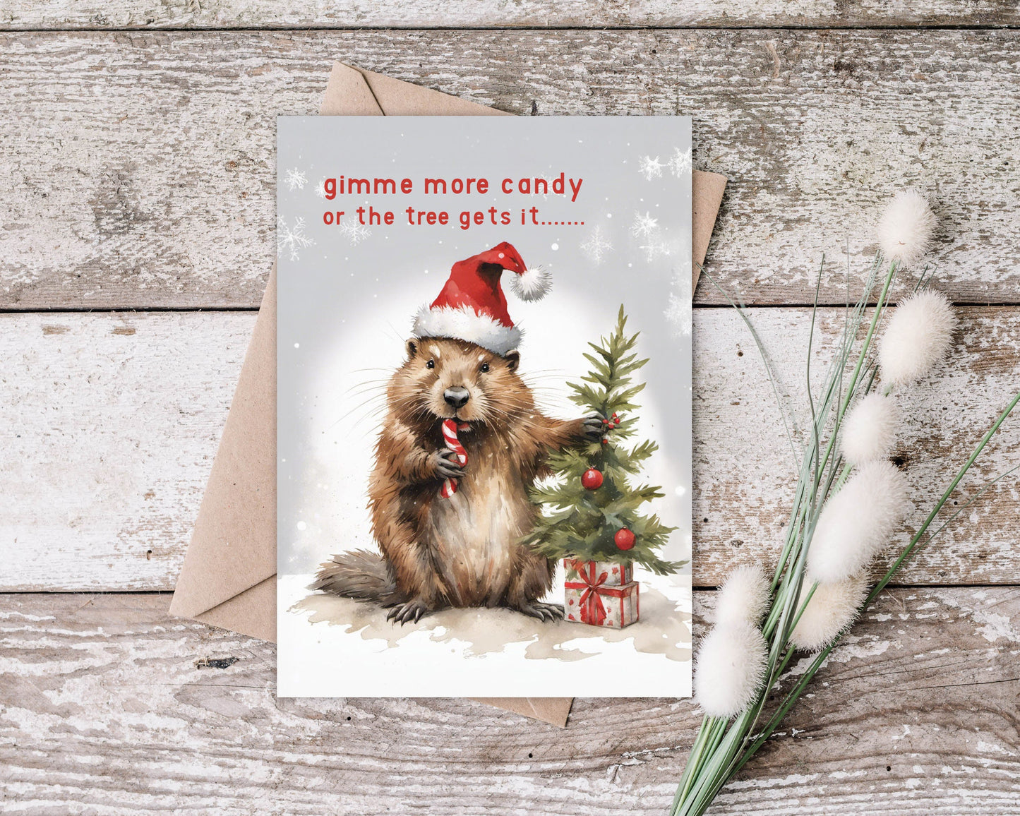 Cute Beaver on a Christmas card with Santa hat wishing you a Merry Christmas